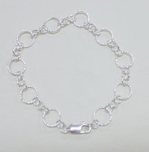 Load image into Gallery viewer, A silver round link bracelet with hammered or polished finish, featuring a large hammered link and three small links and a lobster clasp.